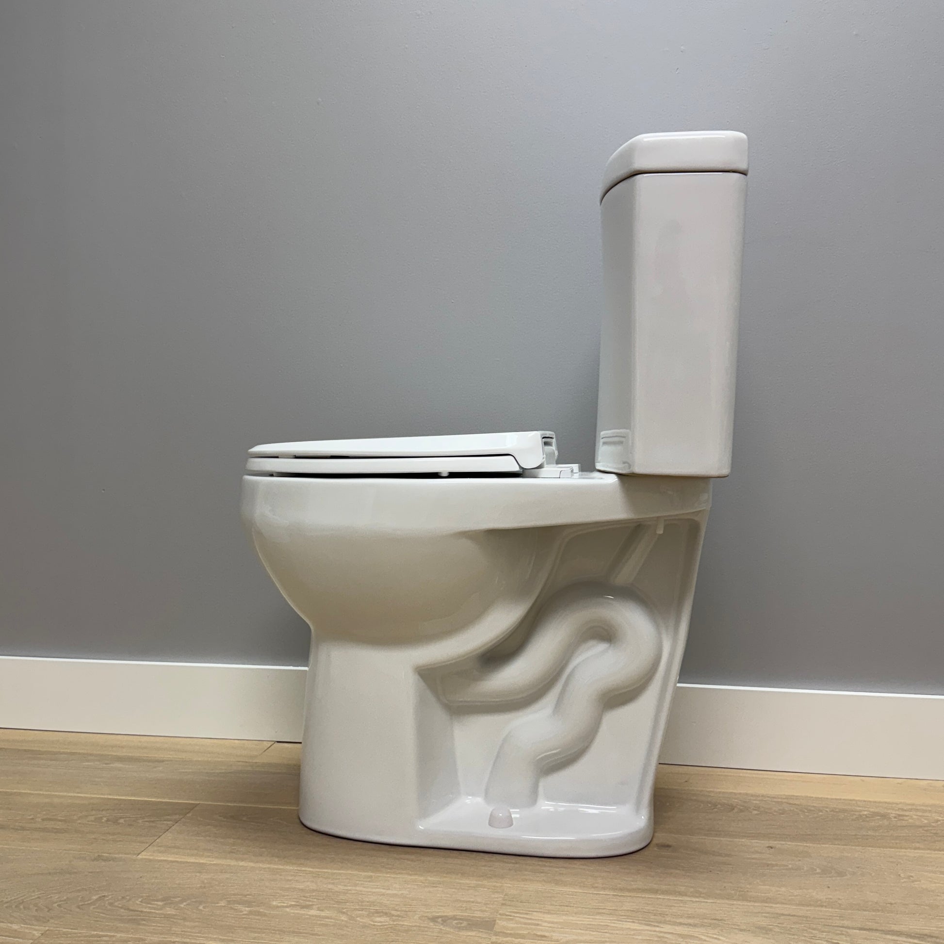 White toilet with artistic design on a gray wall background